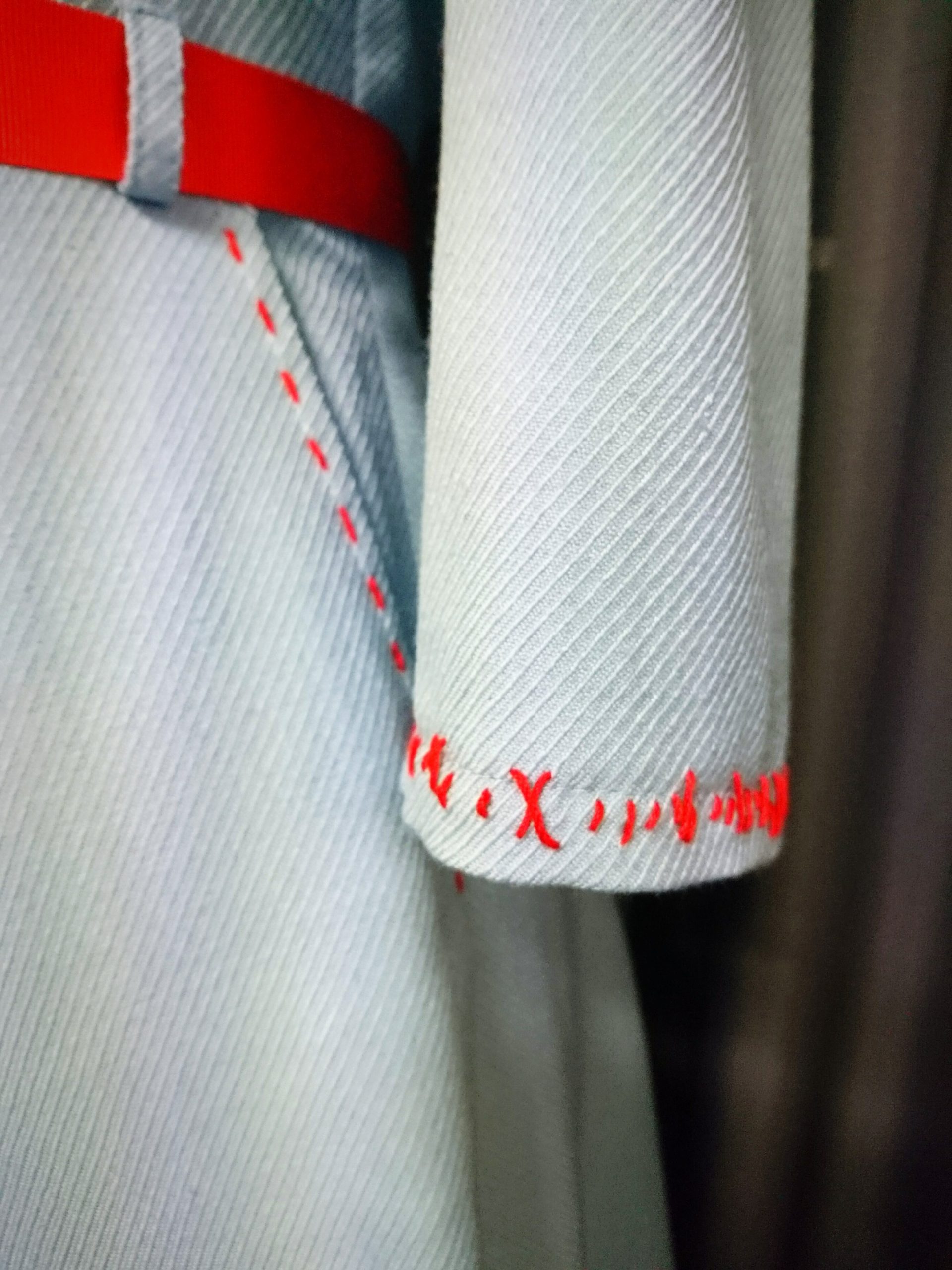 Light blue dress with red stitches