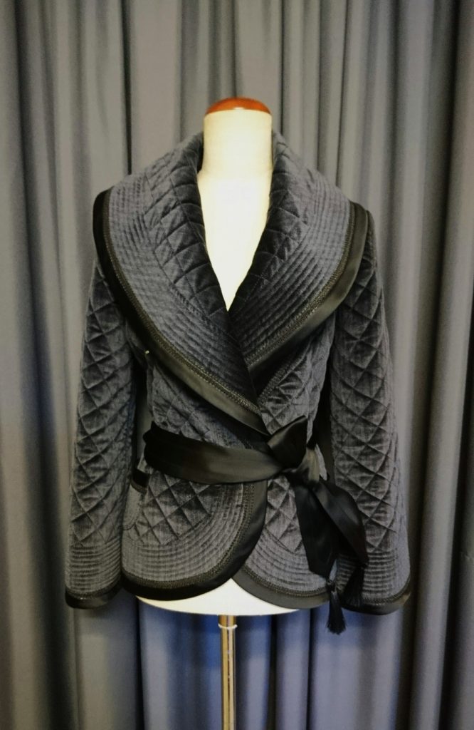quilted gray coat with black bias tape