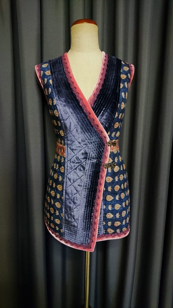 Quilted blue velvet vest with pink details