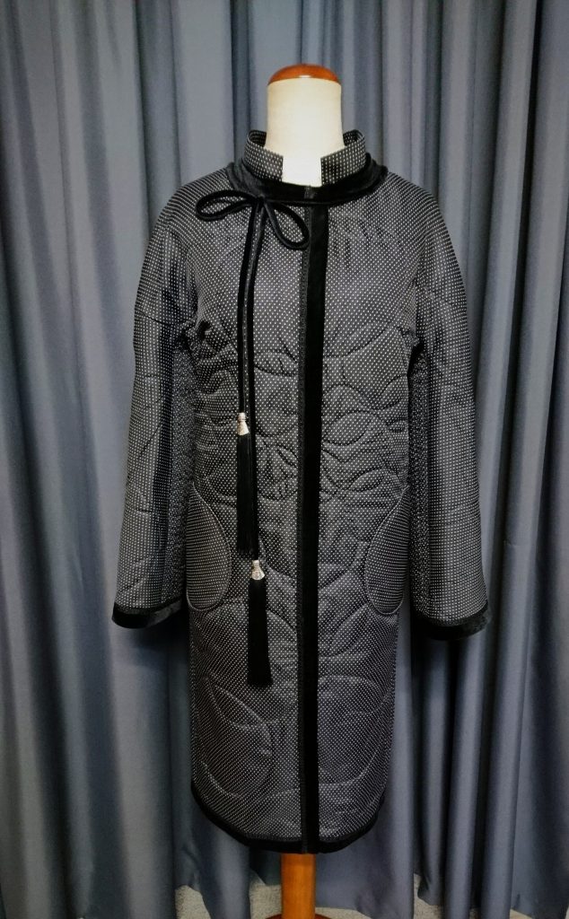 Quilted polka dot coat with black velvet details