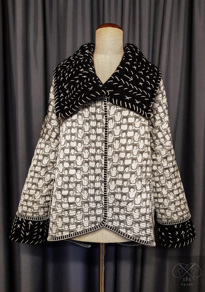Black and white quilted coat with knited details