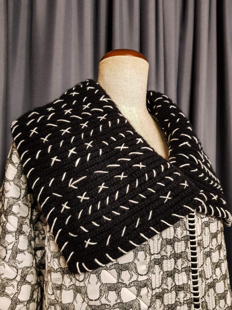 Black and white quilted coat with knited details