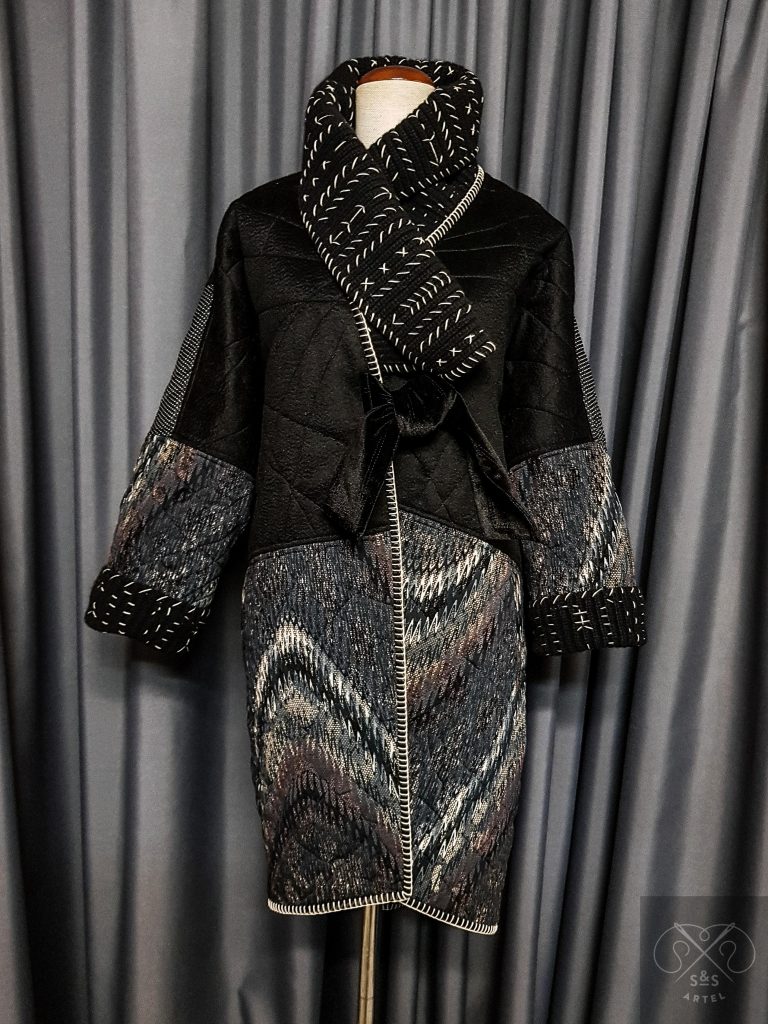 Black quilted coat with knited details