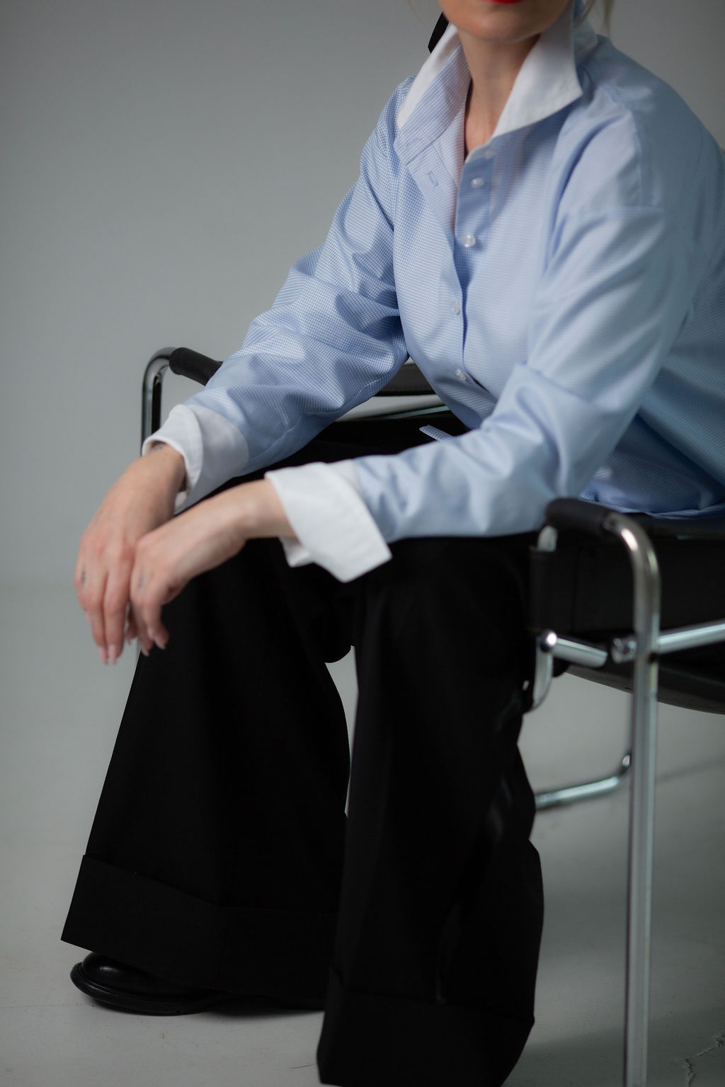Light blue button-up shirt with a crisp white collar and relaxed, elegant fit.