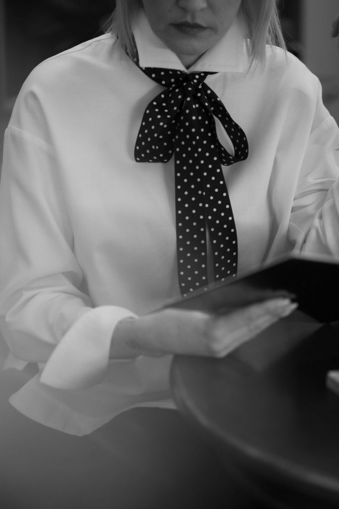 Classic white button-up shirt with a tailored collar and relaxed silhouette, ideal for workwear or elevated casual styling.