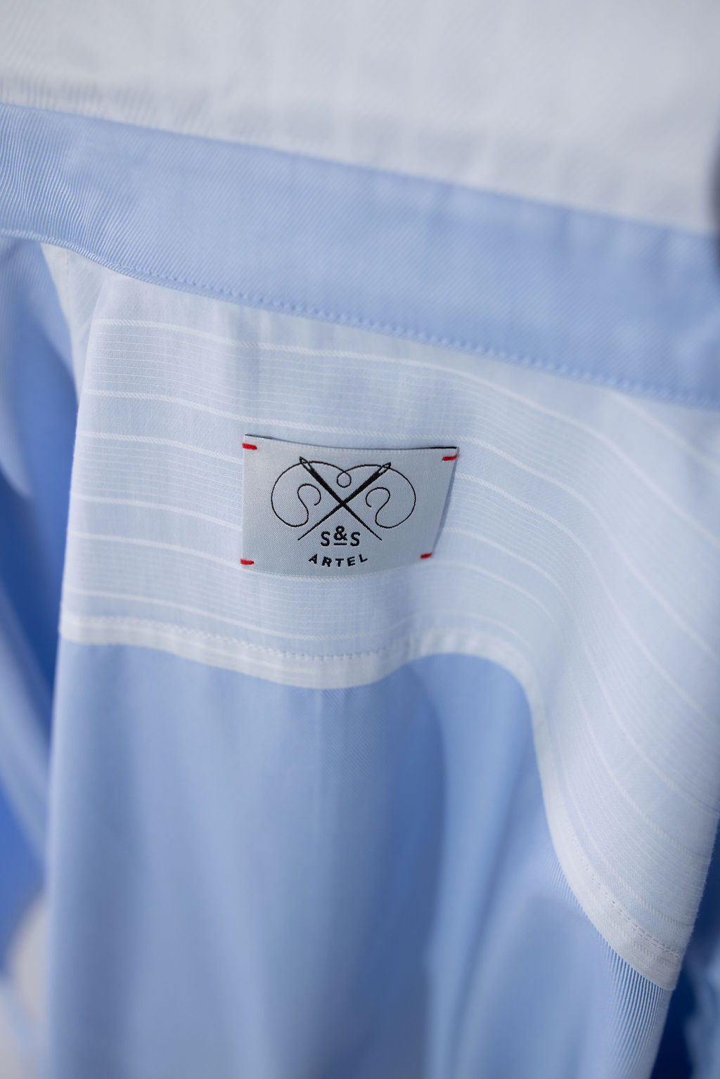 Light blue button-up shirt with a crisp white collar and relaxed, elegant fit.