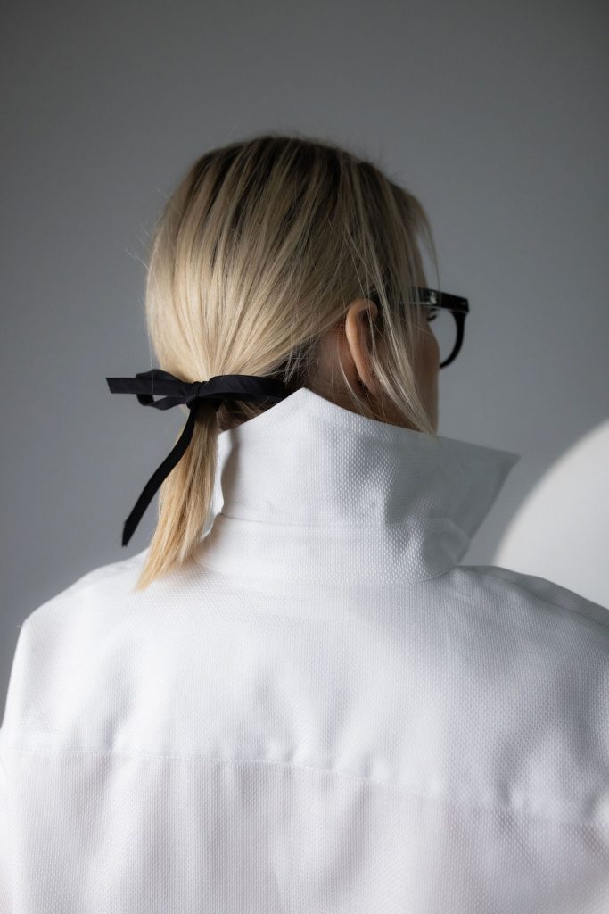White long-sleeve button-up shirt with a crisp collar and relaxed, modern fit.