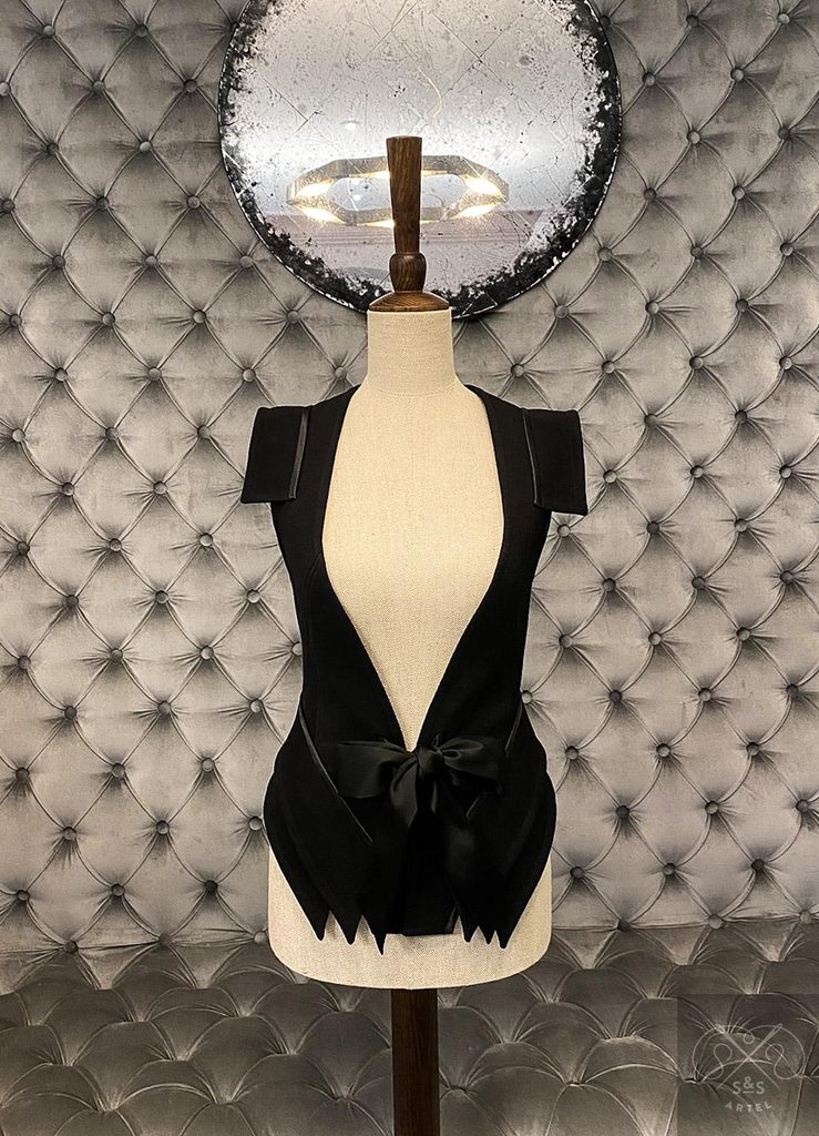 Black vest with decorative shoulder and hips details