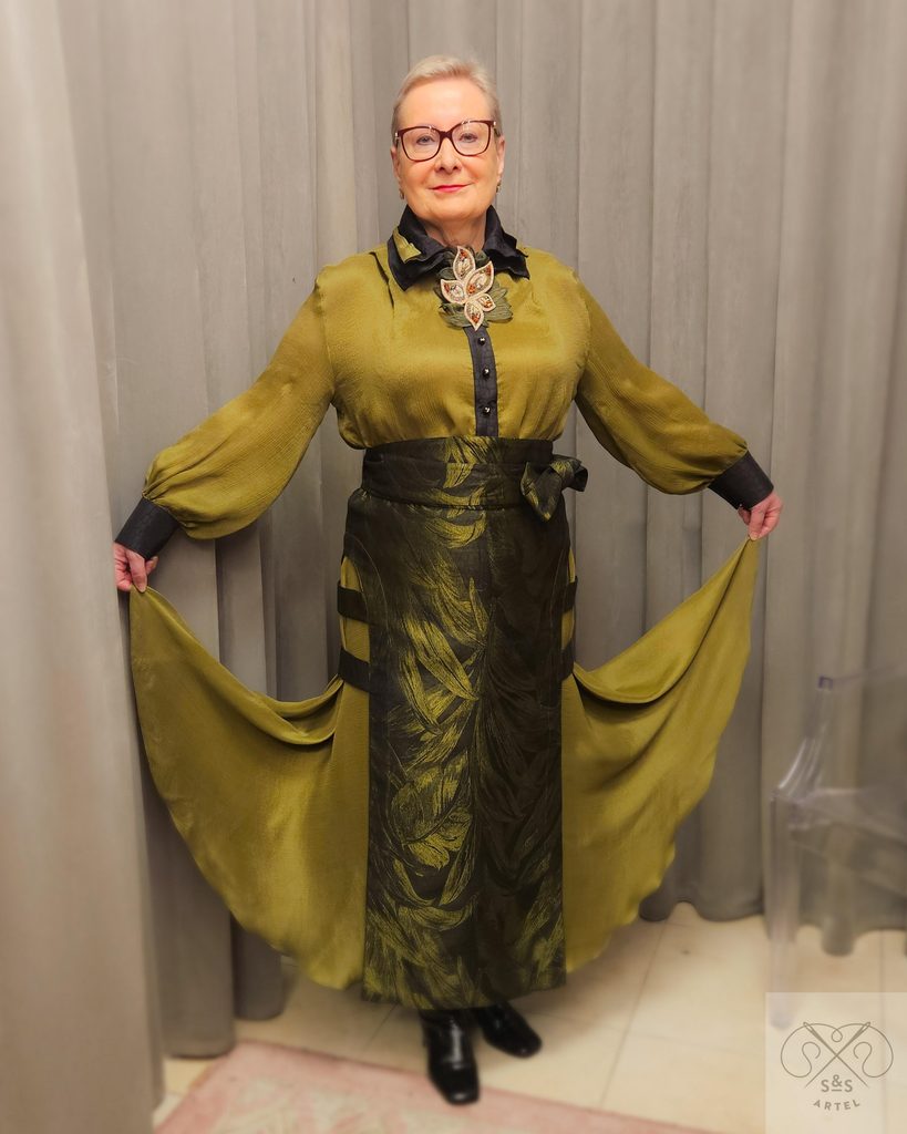 a lady with silk shiffon top an underskirt with green top skirt