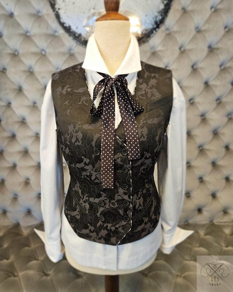 White shirt under vest with black polkadot ribbon